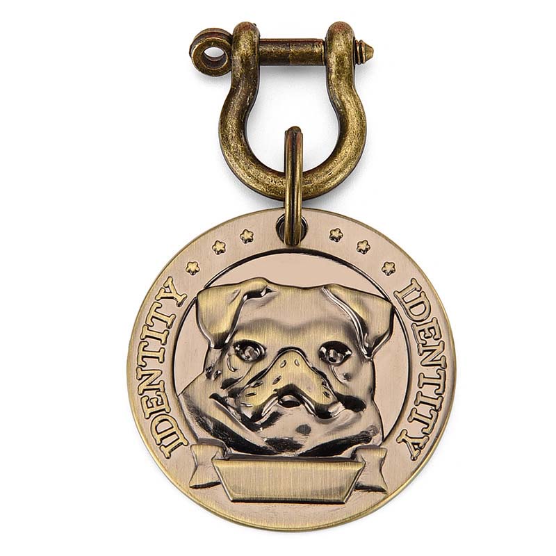 Round metal dog ID tag with a raised Pug design and an antique-tone shackle attachment