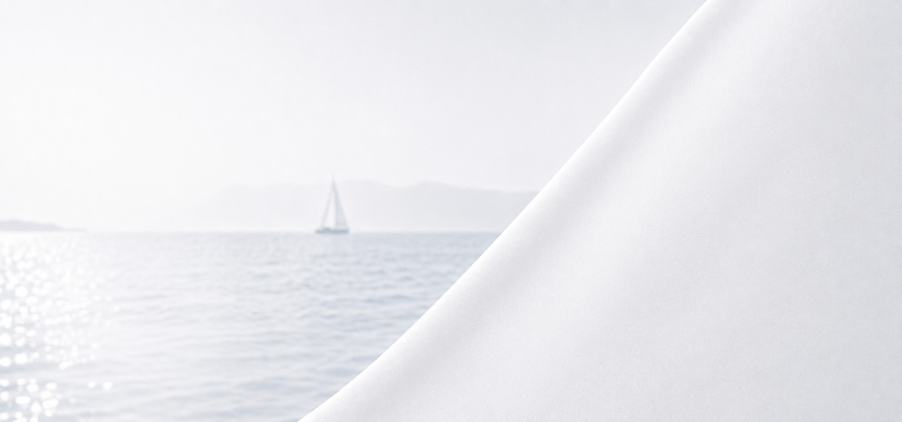 Sailboat on calm water with a white sail detail